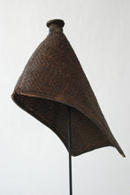 A thickly woven rain hat worn by women of Lugbara and Mangbetu tribes